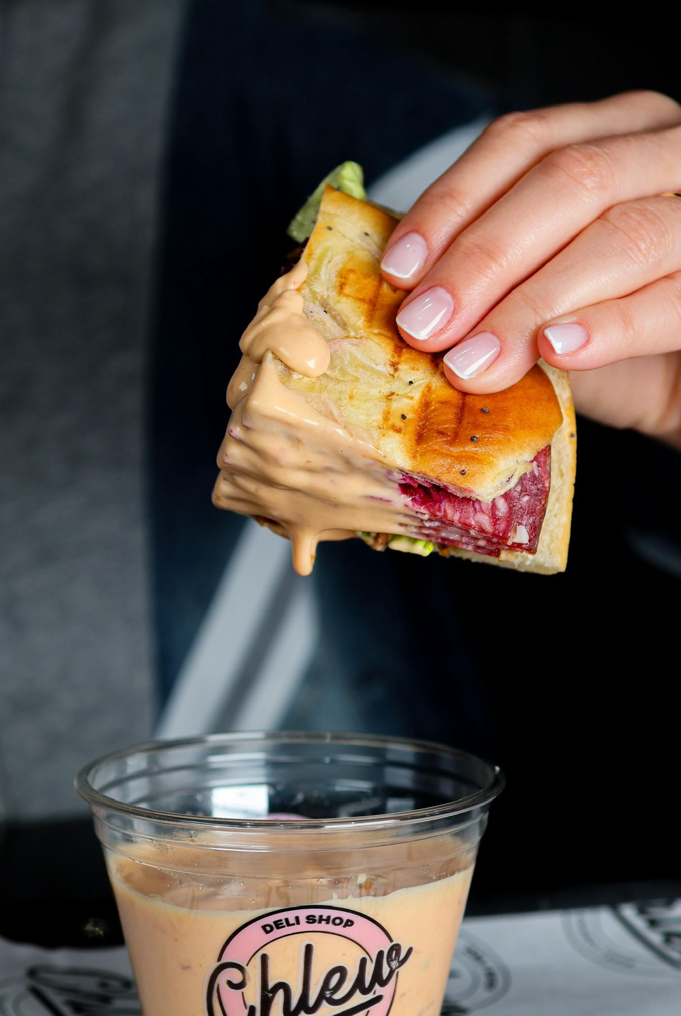 Sandwich dipping in pink sauce